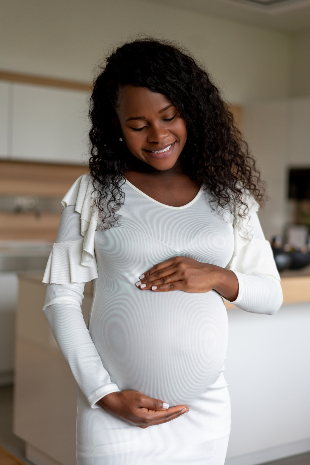 Loving black pregnant woman at home